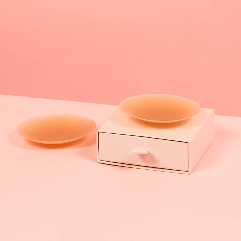 Chocolate nipple covers are placed on a pink Brelese box